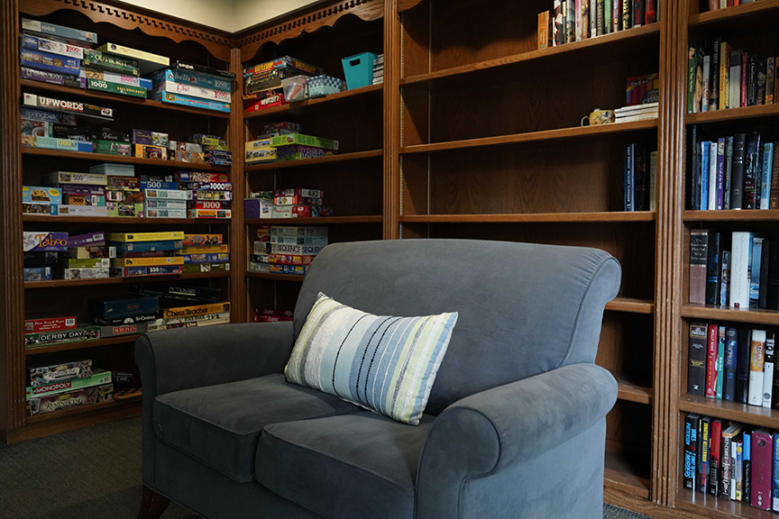 Books and sofa in family lounge- Arbors West