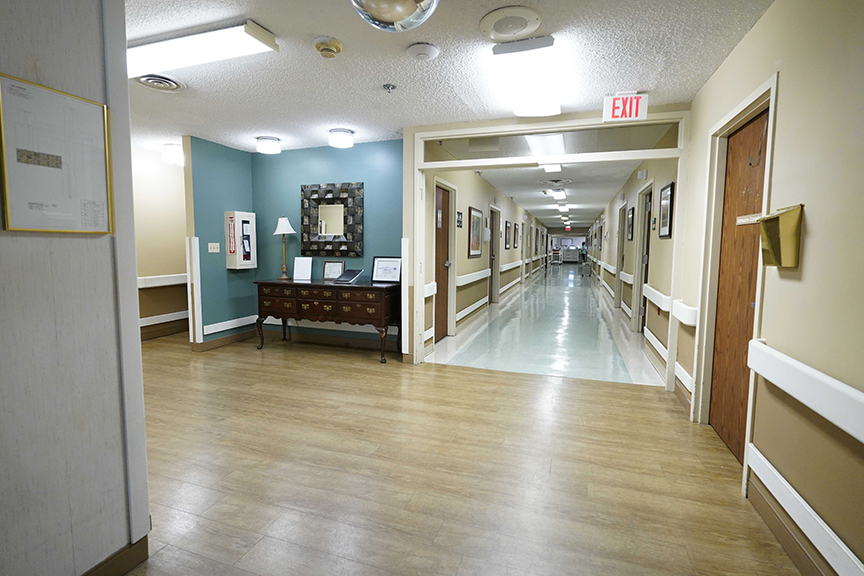 Main hallway with exit sign- Arbors West